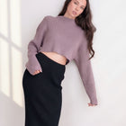 OKAKIE mauve crop ribbed sweater with high neckline and long sleeves worn by a model with a black skirt