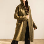 OKAKIE Adrienne heavyweight olive green hooded cardigan with an open front, longline silhouette, and patch pockets.