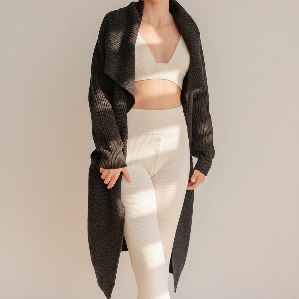 OKAKIE oversized black purl knit coatigan with wide sleeves and patch pockets worn over a cream lounge set