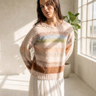 Model wearing an OKAKIE plush high-pile pastel striped sweater with drop shoulders and a crew neckline.