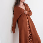 OKAKIE rust longline shawl cardigan with mini-popcorn texture worn by a woman against a white wall