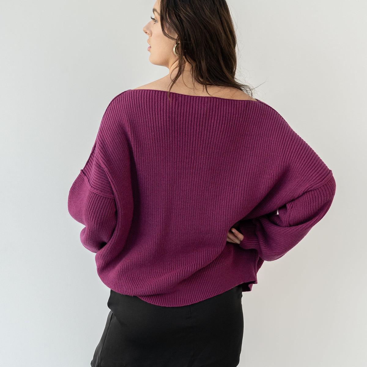 OKAKIE magenta heavy tunic knit sweater with a wide neckline and relaxed drop shoulders, back view on a model.