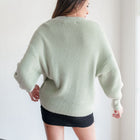 OKAKIE sage green fuzzy mock-neck tunic sweater with relaxed drop shoulders and long sleeves, back view.