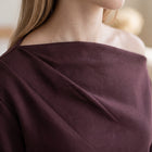 OKAKIE Solène asymmetric scuba knit top in deep plum featuring a sculptural one-shoulder neckline and soft drape.