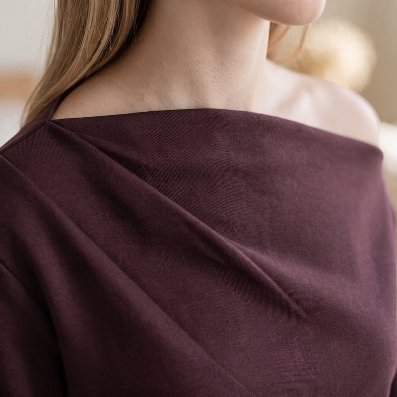 OKAKIE Solène asymmetric scuba knit top in deep plum featuring a sculptural one-shoulder neckline and soft drape.