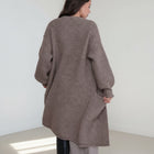 OKAKIE heavy warm purl knit cardigan in taupe brown with long sleeves and a relaxed fit, back view