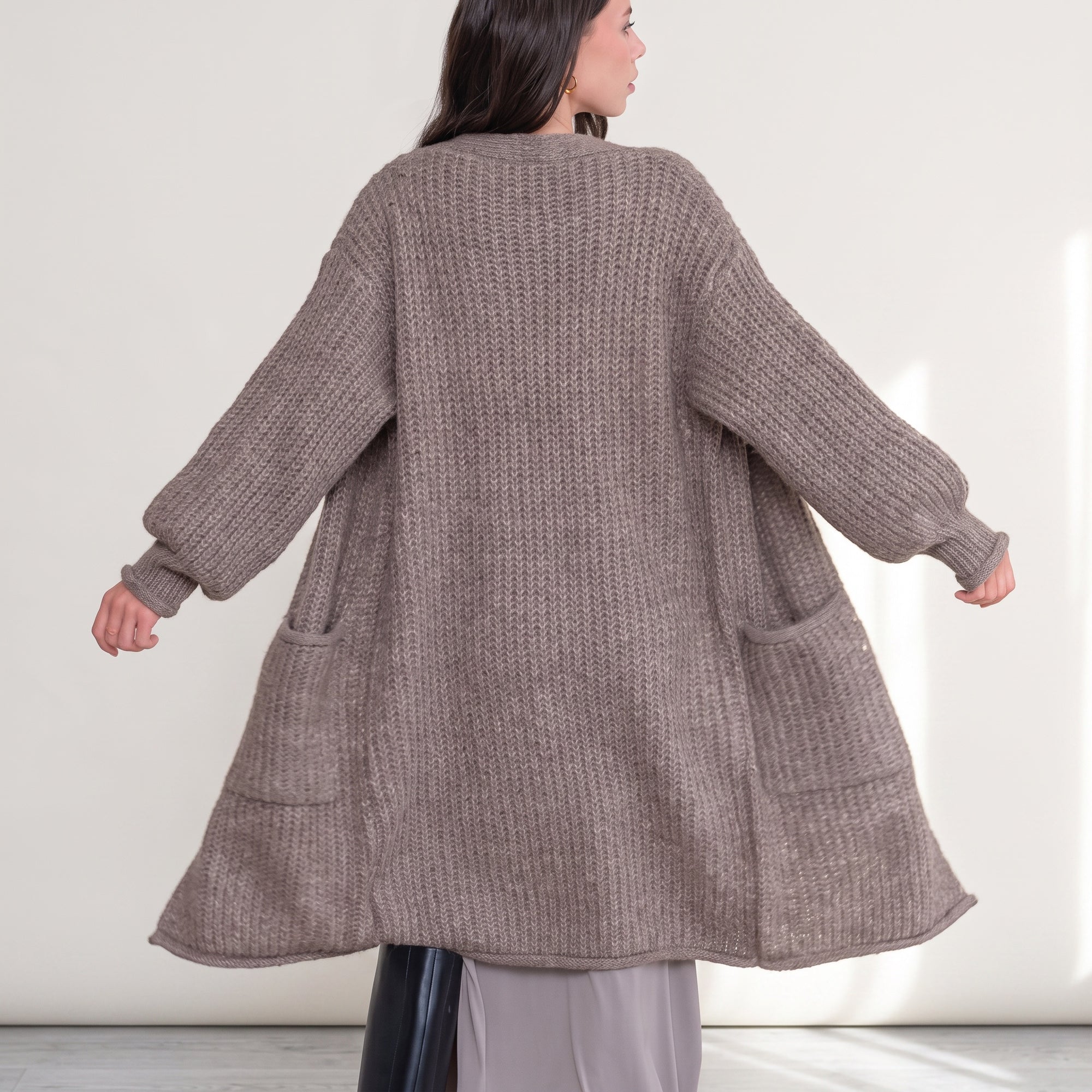 OKAKIE heavy warm purl knit cardigan in taupe with long sleeves and front pockets worn by a woman