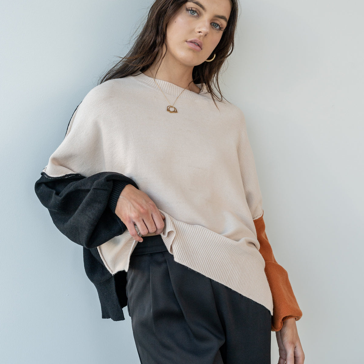 OKAKIE Solène three-tone oversized knit sweater in cream, charcoal, and rust with drop shoulders and ribbed trim.