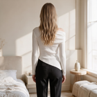OKAKIE white asymmetric draped sweater top with long sleeves and ribbed texture worn by a woman, back view