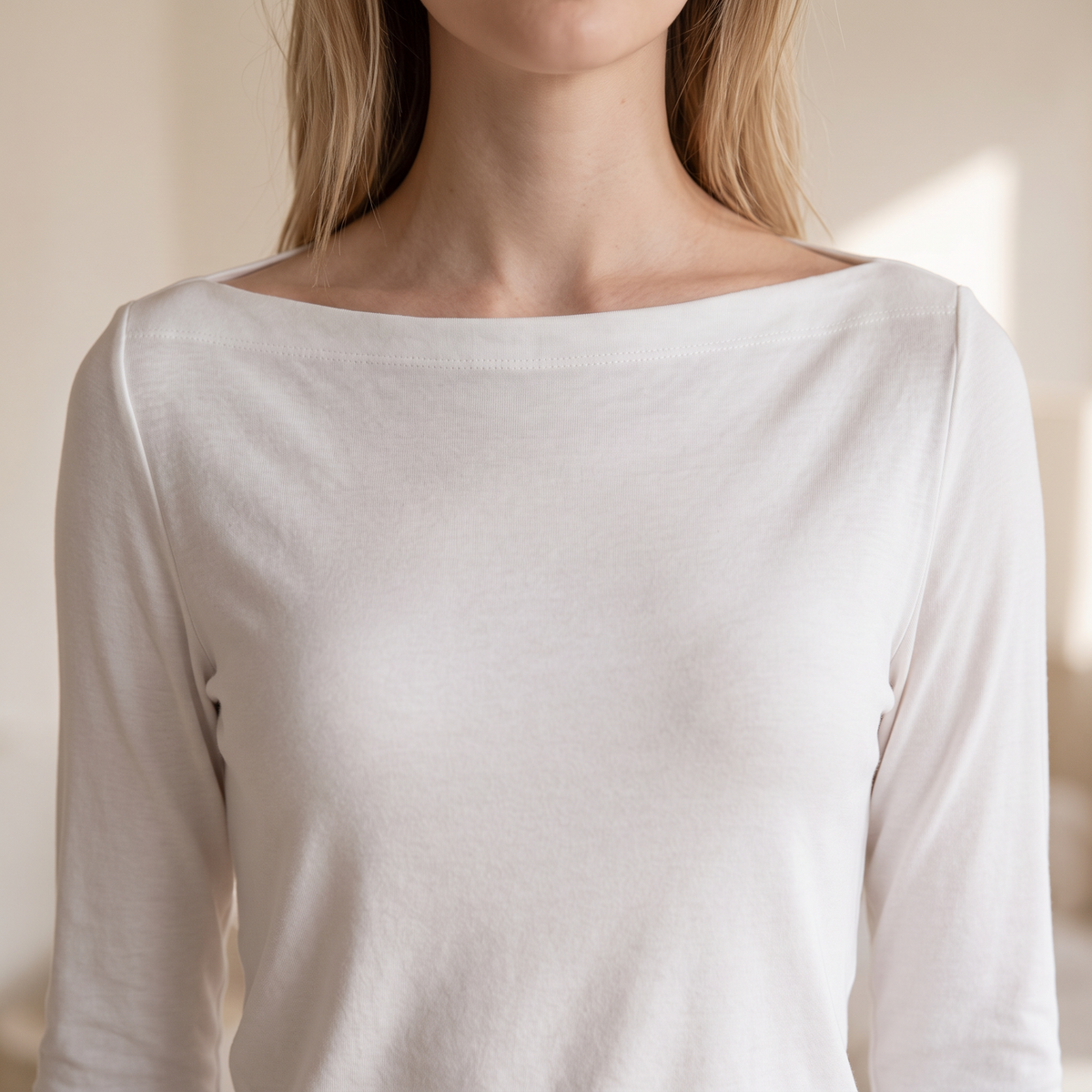 OKAKIE white long-sleeve top with a wide boat neckline in a soft brushed knit fabric for a relaxed feminine fit.